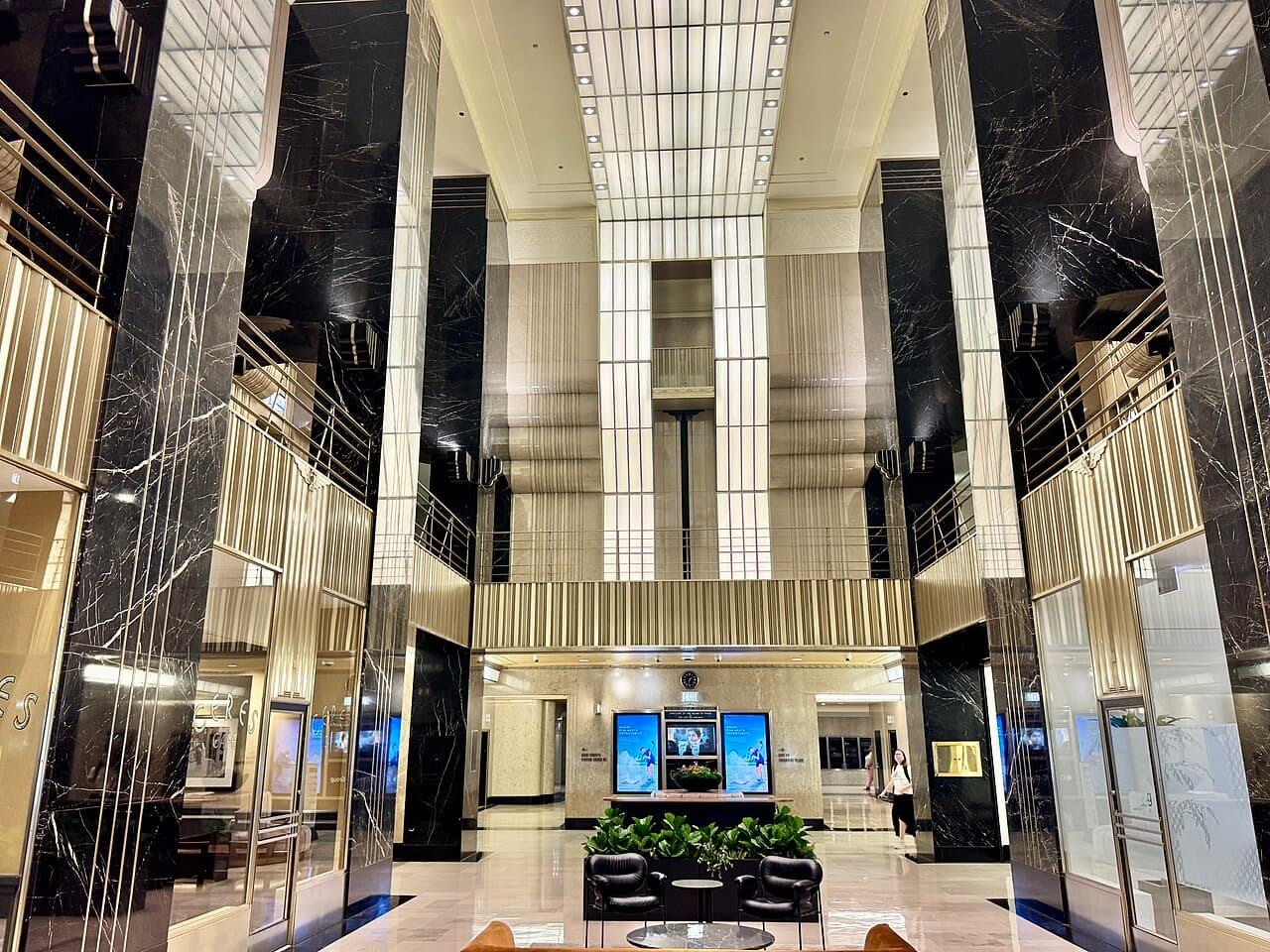 The Art Deco lobby of the Chicago Board of Trade Building, with black marble piers and a tall lit atrium, July 2025.